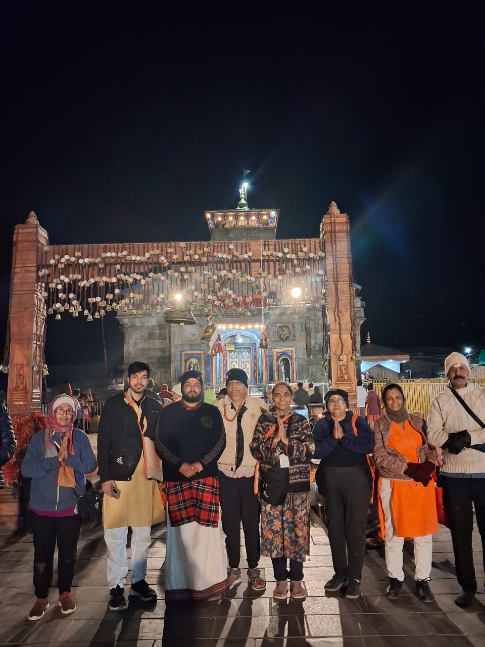 Group at Kedarnath temple gate at night
