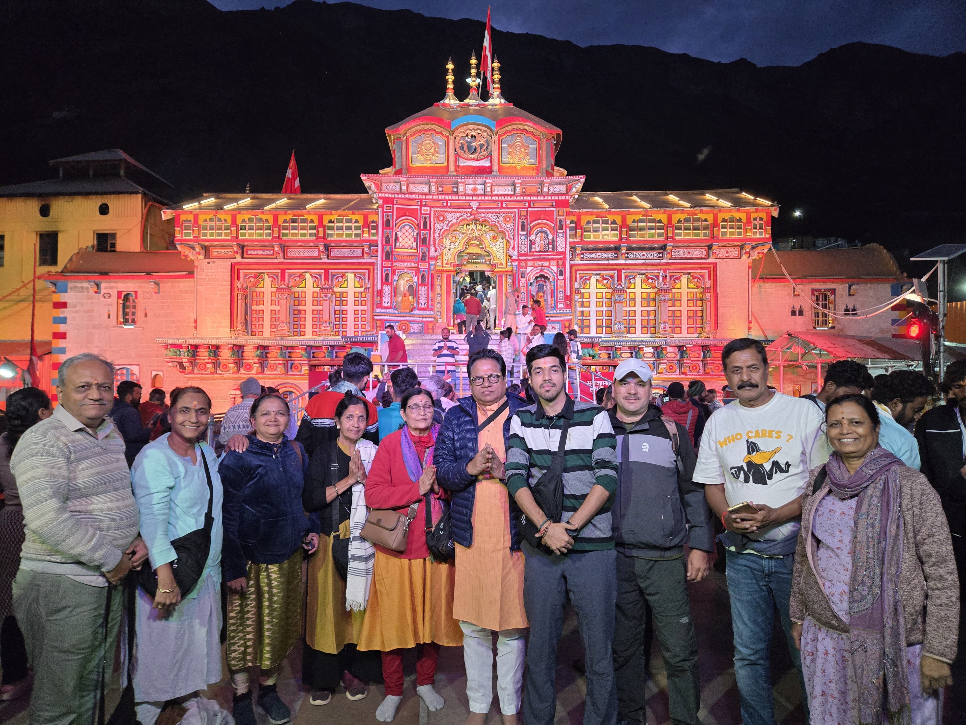 Group at Badrinath temple illuminated at night