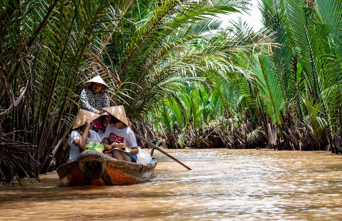 Mekong Delta boat through palm canal